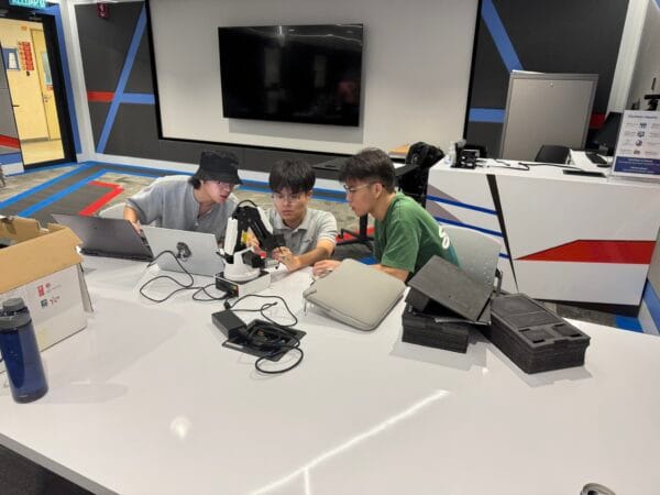 Apulsar's trainer Zhi Xuan Kong is teaching 2 university students to configure Dobot Magician